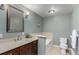 Bathroom featuring a large mirror, a marble-topped vanity, and a separate tub area at 2365 S Holly Pl, Denver, CO 80222