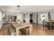 Dining room showcasing a rustic wooden table and chairs, with view to the kitchen at 2365 S Holly Pl, Denver, CO 80222