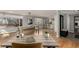 A dining room with hardwood floors and bright natural light, and a glimpse of the kitchen at 2365 S Holly Pl, Denver, CO 80222