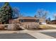 Charming brick ranch-style home with mature trees, a driveway, and a two-car garage at 2365 S Holly Pl, Denver, CO 80222