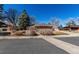 Charming brick ranch-style home with mature trees, a driveway, and a two-car garage at 2365 S Holly Pl, Denver, CO 80222