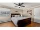 Spacious main bedroom showcases hardwood floors, a ceiling fan, and a comfortable king-size bed at 2365 S Holly Pl, Denver, CO 80222