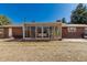 Backyard featuring a brick home with sunroom with sliding glass doors at 2365 S Holly Pl, Denver, CO 80222