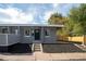 Newly renovated home with gray brick exterior and landscaping at 2401 W 39Th Ave, Denver, CO 80211