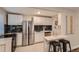 Updated kitchen featuring white cabinets, stainless steel appliances, and dark tile backsplash at 2401 W 39Th Ave, Denver, CO 80211