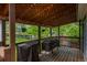 Inviting covered back porch with lattice roof, ideal for outdoor gatherings and enjoying the peaceful scenery at 9150 W 94Th Ave, Westminster, CO 80021