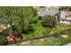 Spacious backyard with lush green grass and mature trees, enclosed by a wooden fence at 9150 W 94Th Ave, Westminster, CO 80021