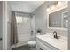 Well-lit bathroom features a white vanity, stylish fixtures, and a shower with white subway tile at 9150 W 94Th Ave, Westminster, CO 80021