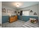 Cozy bedroom featuring a gray carpet, gray and white walls, and a twin bed with stuffed animals at 9150 W 94Th Ave, Westminster, CO 80021