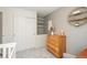 Bedroom closet featuring shelving next to a natural wood dresser with a wall hanging at 9150 W 94Th Ave, Westminster, CO 80021
