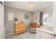 Comfortable Bedroom features a recliner, window, and a white baby crib with patterned bedding at 9150 W 94Th Ave, Westminster, CO 80021