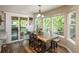 Bright dining room with large windows, a rustic wood table, and access to an outdoor deck at 9150 W 94Th Ave, Westminster, CO 80021