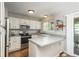 Functional kitchen with stainless steel appliances, white cabinets, and a view to the outside at 9150 W 94Th Ave, Westminster, CO 80021