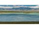 Scenic view of a lake surrounded by mountains and green landscapes under a partly cloudy sky at 9150 W 94Th Ave, Westminster, CO 80021