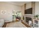 Inviting living room with a fireplace, open layout to dining area, and plenty of natural light at 9150 W 94Th Ave, Westminster, CO 80021