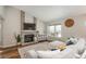 Cozy living room with a brick fireplace, modern furnishings, and a large window offering plenty of natural light at 9150 W 94Th Ave, Westminster, CO 80021