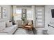 Cozy living room featuring a comfortable couch, stylish decor, and ample natural light from large windows at 21823 E 8Th Ave, Aurora, CO 80018