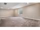 Well-lit finished basement space with neutral color palette and plush carpeting for comfort at 6674 Fonder Villa Dr, Parker, CO 80134
