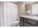 Modern bathroom with granite countertop, shower with white curtain, and vanity with dark wood cabinets at 6674 Fonder Villa Dr, Parker, CO 80134