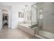 Bright bathroom featuring soaking tub, glass-enclosed shower and access to a spacious walk-in closet at 6674 Fonder Villa Dr, Parker, CO 80134
