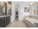 Spacious bathroom featuring a double vanity, soaking tub, and walk-in closet access at 6674 Fonder Villa Dr, Parker, CO 80134