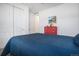 Bedroom with sliding-door closet, a red dresser and a bed with a blue quilt at 6674 Fonder Villa Dr, Parker, CO 80134