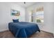 Cozy bedroom with blue comforter, shuttered windows, and neutral carpet flooring at 6674 Fonder Villa Dr, Parker, CO 80134