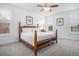 Bright bedroom with a wooden frame bed, plush carpet, and natural light from windows at 6674 Fonder Villa Dr, Parker, CO 80134