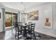 Inviting dining area with slider door access to the backyard, neutral decor and modern lighting at 6674 Fonder Villa Dr, Parker, CO 80134