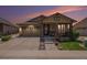 Evening shot of the home's exterior showcasing the well-kept lawn and craftsman architecture at 6674 Fonder Villa Dr, Parker, CO 80134