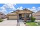 Charming single Gathering home with a stone pillar entryway, well manicured lawn, and a two-car garage at 6674 Fonder Villa Dr, Parker, CO 80134
