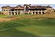 View of the Golf Club at Pradera from behind the green, with a large building in the distance at 6674 Fonder Villa Dr, Parker, CO 80134