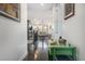 Hallway featuring wood floors leading to the living room, with a green desk and artwork at 6674 Fonder Villa Dr, Parker, CO 80134