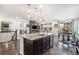 Modern kitchen featuring a granite countertop island, pendant lighting, and dark cabinetry at 6674 Fonder Villa Dr, Parker, CO 80134