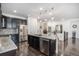 Bright kitchen boasts stainless appliances, granite counters, and an island with barstool seating at 6674 Fonder Villa Dr, Parker, CO 80134