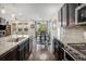 Kitchen featuring stainless steel appliances, gas cooktop, island seating, and easy access to dining and living area at 6674 Fonder Villa Dr, Parker, CO 80134