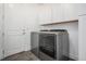 Well-organized laundry room features a modern washer and dryer set, and storage cabinets at 6674 Fonder Villa Dr, Parker, CO 80134