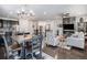 Open-concept living area featuring a fireplace, dining area, hardwood floors, and an island with seating at 6674 Fonder Villa Dr, Parker, CO 80134