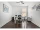 A bright office with sleek desk and storage solutions, complemented by dark wood floors at 6674 Fonder Villa Dr, Parker, CO 80134