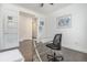 Bright office featuring hardwood floors, white walls and trim, and a glass-top desk at 6674 Fonder Villa Dr, Parker, CO 80134
