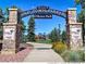 Welcome to the Old Town Parker entrance featuring well-maintained landscaping and a playground in the background at 6674 Fonder Villa Dr, Parker, CO 80134
