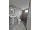Bathroom featuring a pedestal sink and tiled shower at 2865 Carnation Way, Thornton, CO 80229