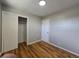 Charming bedroom featuring a closet, windows, and hardwood floors at 2865 Carnation Way, Thornton, CO 80229