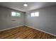 Well-lit bedroom with windows and hardwood floors at 2865 Carnation Way, Thornton, CO 80229