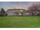 A well-maintained home with a spacious backyard, patio, and lush green lawn at 5467 W Hinsdale Pl, Littleton, CO 80128