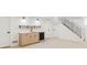 Finished basement with wet bar featuring a wine fridge, light wood cabinets, and floating shelves at 5467 W Hinsdale Pl, Littleton, CO 80128