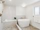 Bathroom with modern tub, walk-in shower and luxurious fixtures, providing a relaxing experience at 5467 W Hinsdale Pl, Littleton, CO 80128