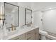 Modern bathroom with a double vanity, stylish mirrors, and a walk-in shower with bronze hardware at 5467 W Hinsdale Pl, Littleton, CO 80128