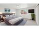 Beautiful bedroom features a large bed with soft linens, large windows, and a wall-mounted television at 5467 W Hinsdale Pl, Littleton, CO 80128