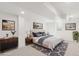 Modern bedroom with soft carpet, a dresser, bedside tables and lamps and large windows at 5467 W Hinsdale Pl, Littleton, CO 80128